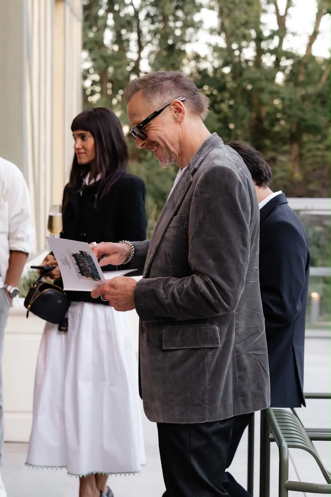 Simon Pegg consultant une carte sur la terrasse de Maison Douce Époque, avec Sofia Boutella